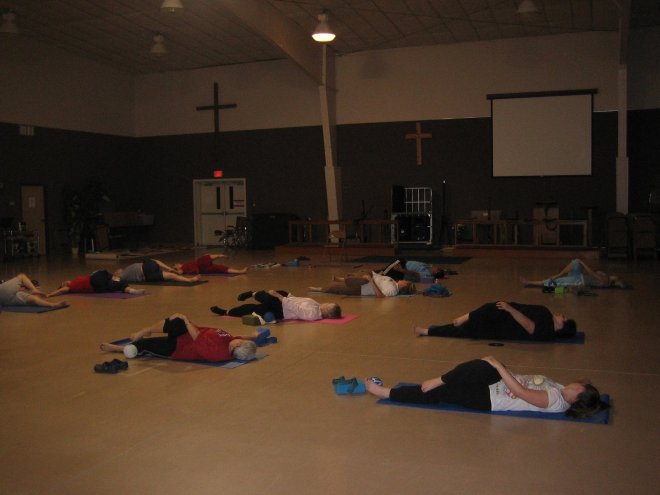Low lumbar twist in mat yoga class with Gail P-B.